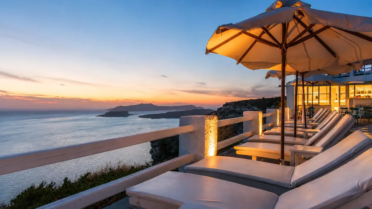Swimming pool and loungers at Artemis Suites in Megalochori