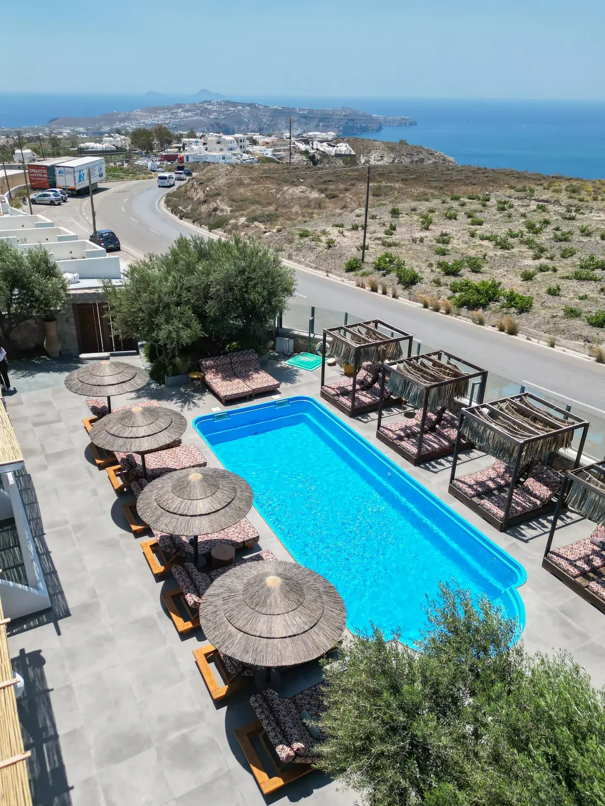 Pool and terraces at Impressive One Santorini seen from above