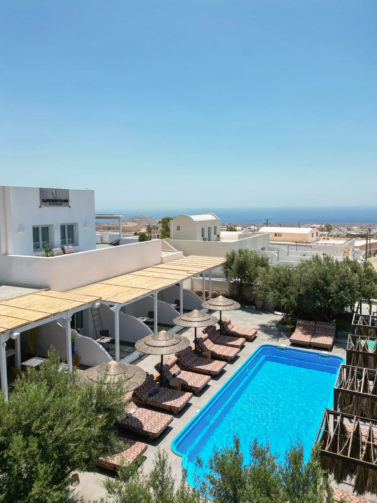 Whitewashed exterior and pool area of Impressive One Santorini