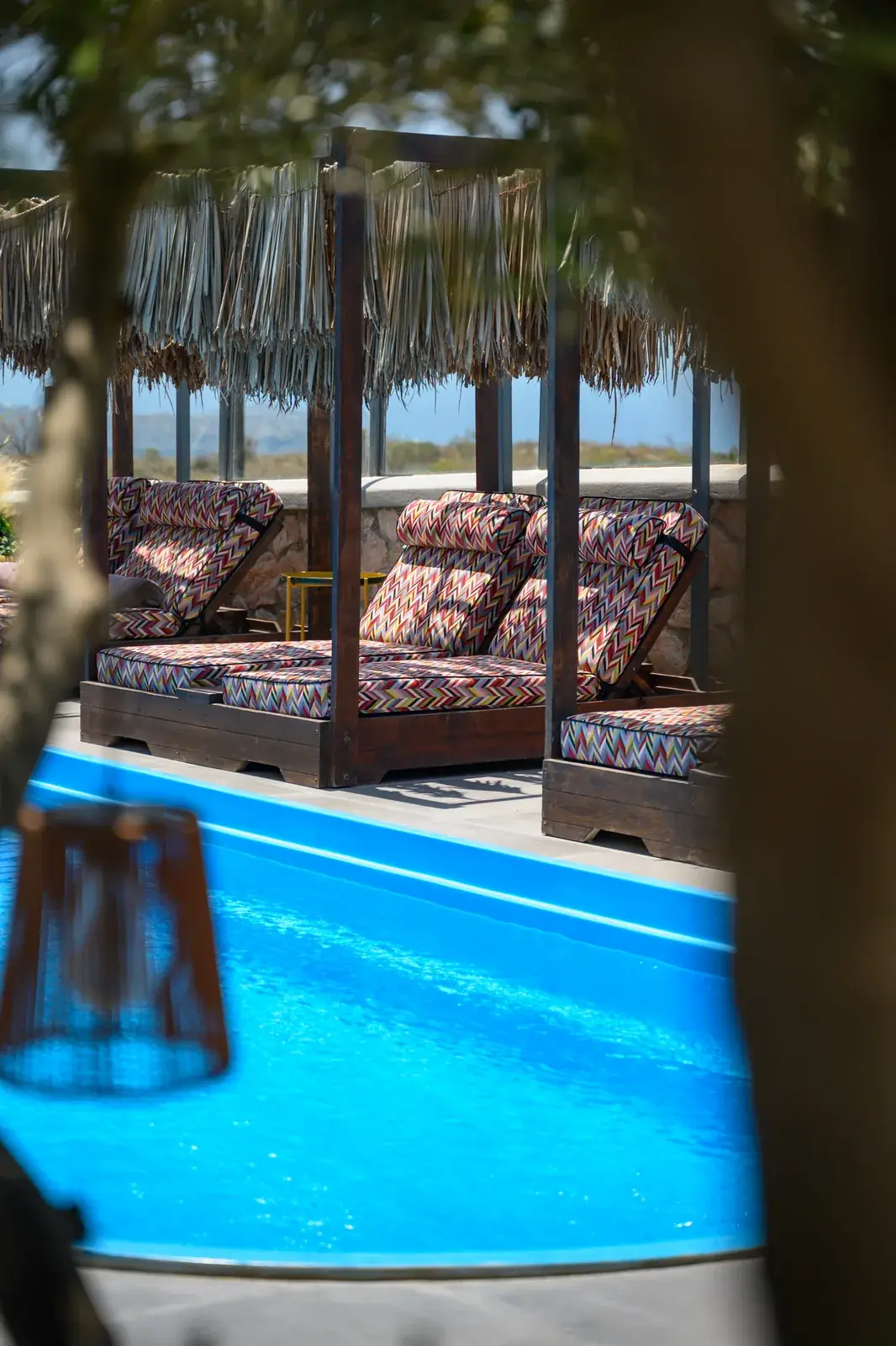 Poolside seating at Impressive One Santorini near Pyrgos