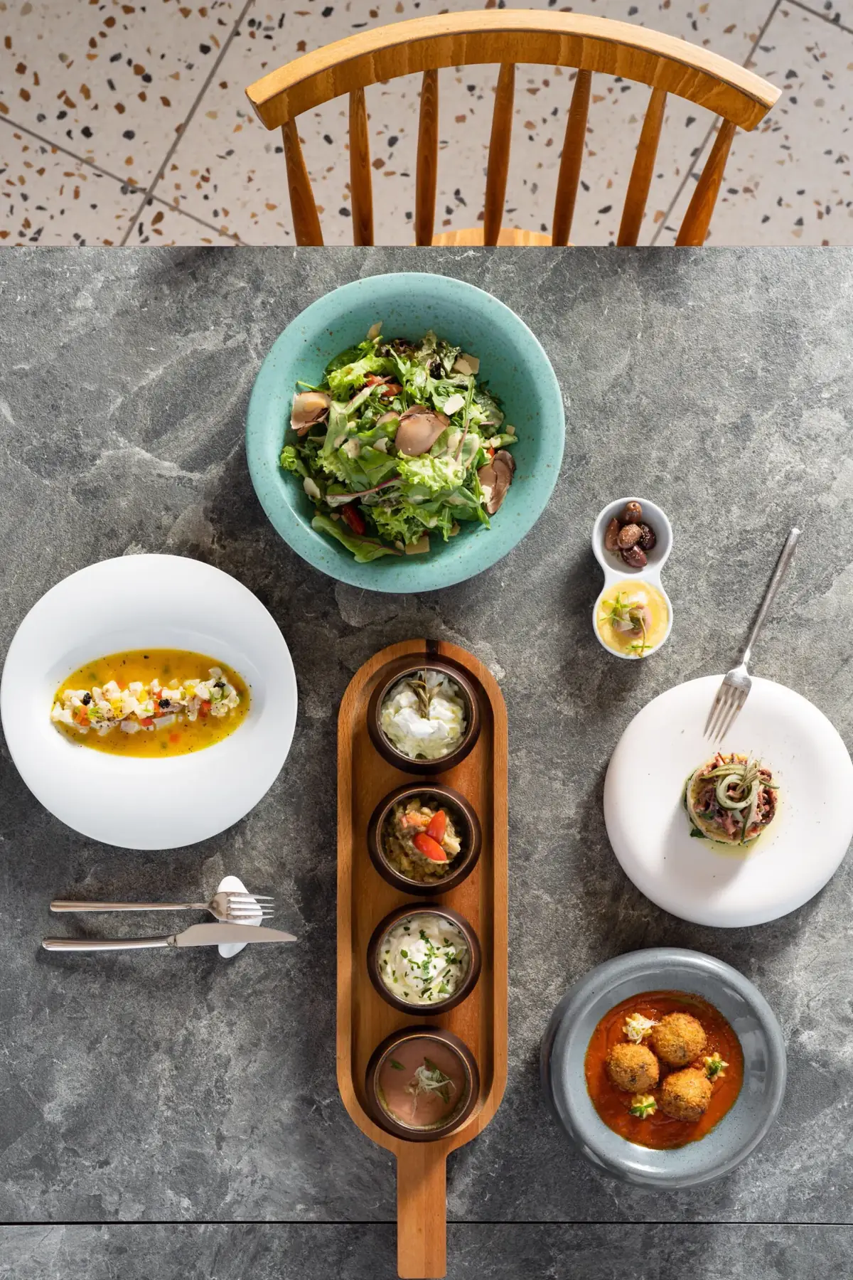 Plated Mediterranean dish with white wine at Theofanis Food Experience